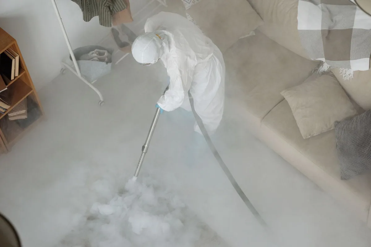 Biohazard cleanup technician in protective equipment, Little Flock, AR